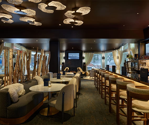 Interior of a hotel bar with modern decor and seating arrangements.