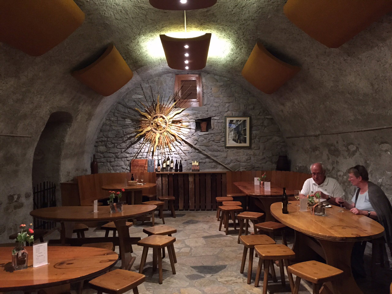 6. Lavaux, Switzerland, features a striking golden sunburst decoration on its stone wall.