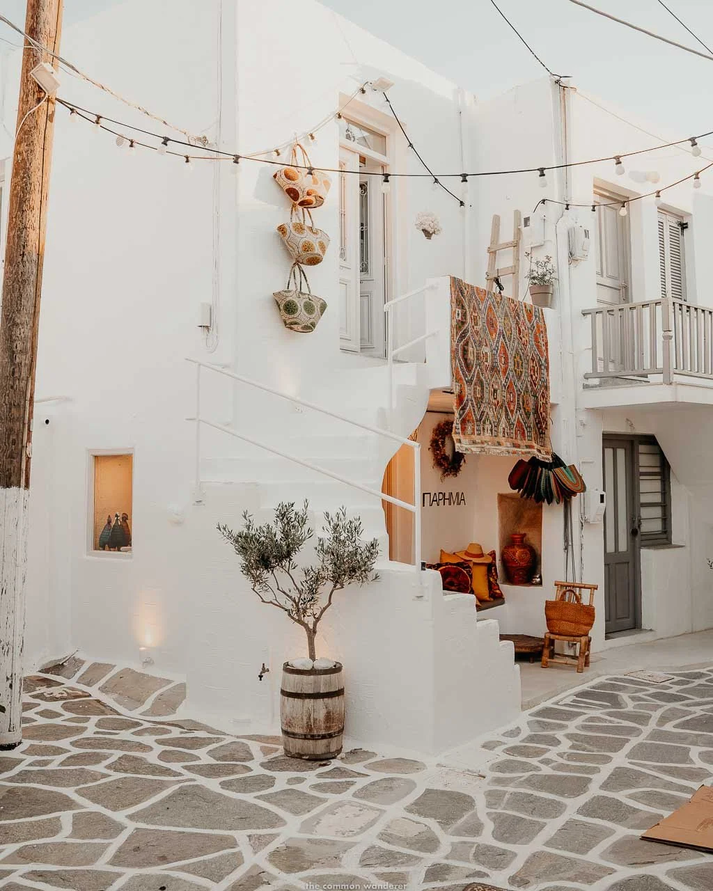 9. Naoussa, Greece, features a charming olive tree in a wooden barrel.