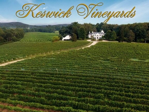 Aerial view of Keswick Vineyards showing extensive vineyard rows surrounding a white manor house in Virginia, with "Keswick Vineyards" text.