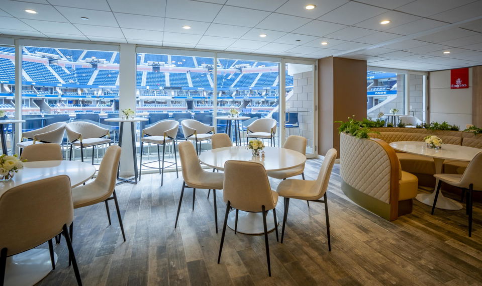 An Arthur Ashe Stadium suite offers a luxurious dining area with views of the tennis court.