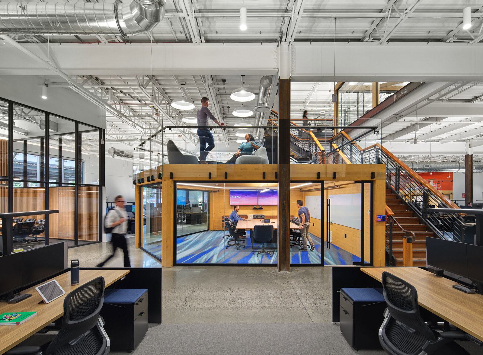 Cariad features a bright, open-plan office with a prominent mezzanine level.