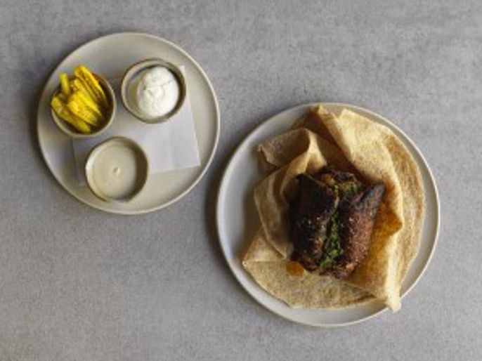 Aalia Wine Room: Paul Farag's lamb hawashi with khorasan pita, labneh, pickled vegetables, and dipping sauce.