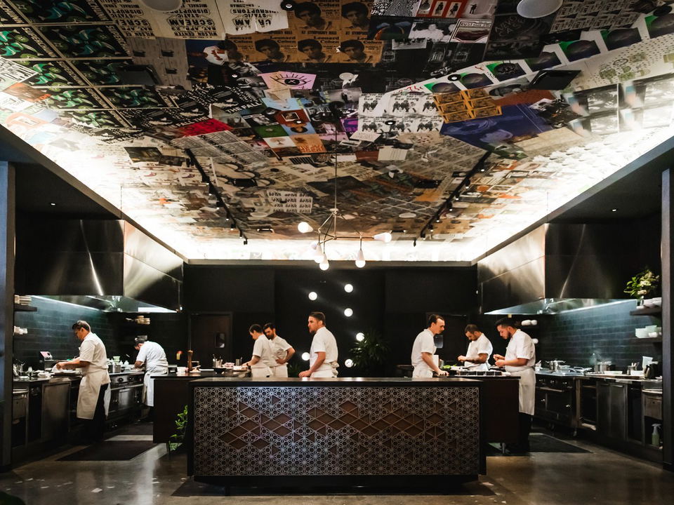 Chefs working in a modern kitchen with a unique ceiling