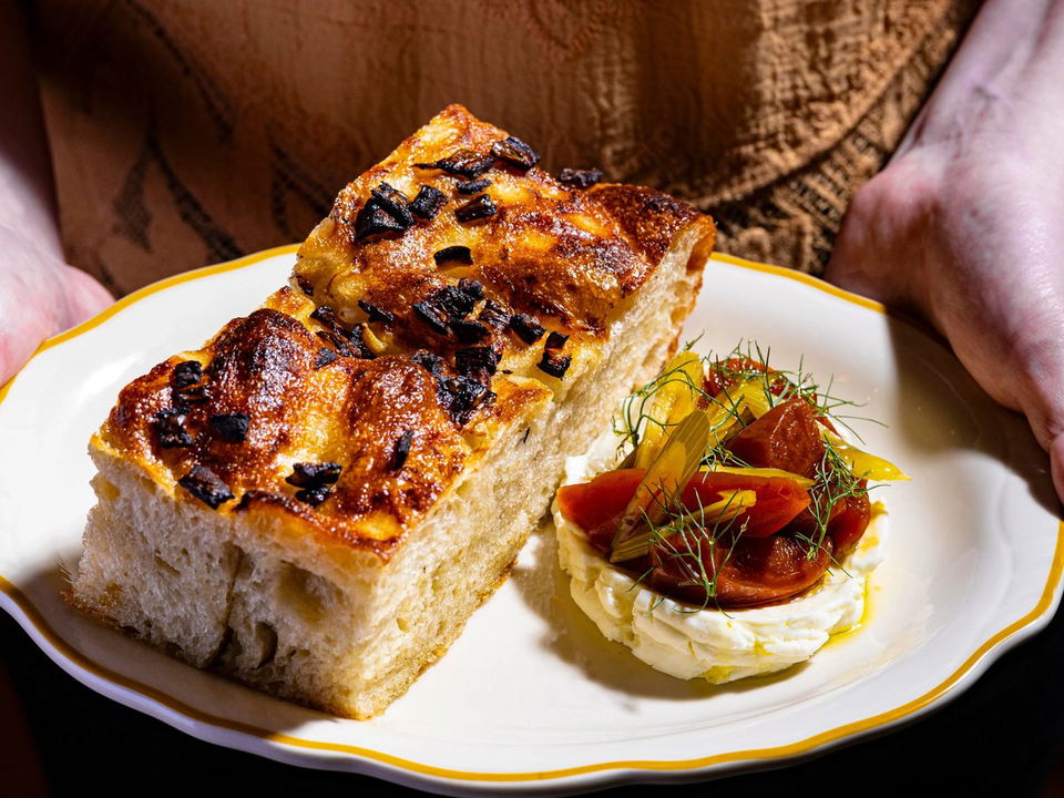 All Well Chicago's focaccia with caramelized onions and a side of tomatoes with cheese and herbs.