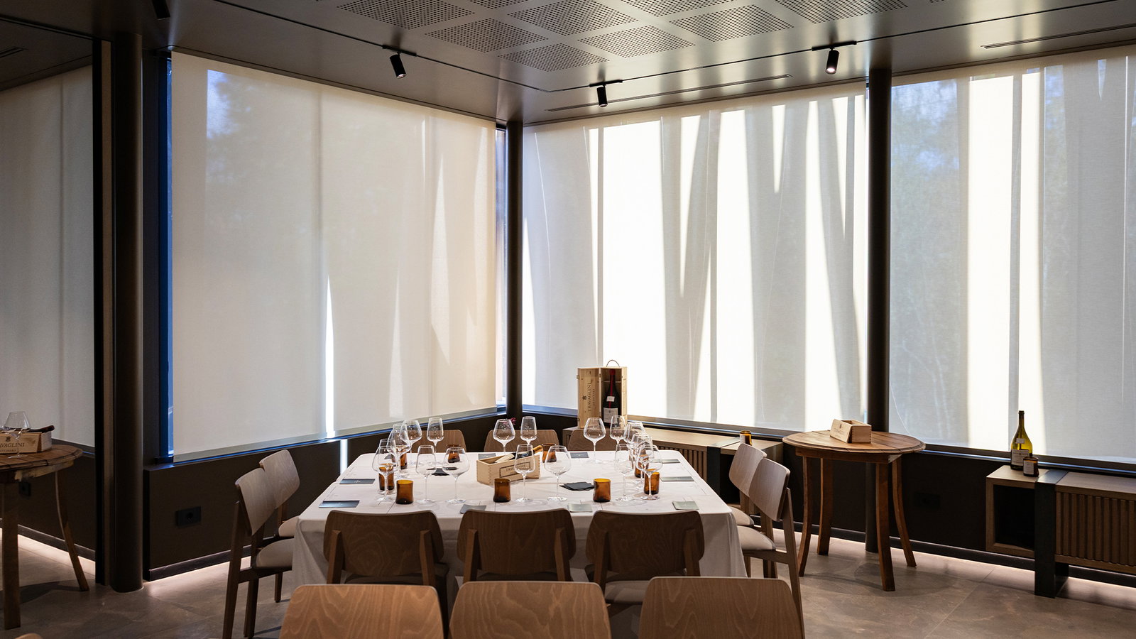 Travaglini (Gattinara) features large windows covered by bright, translucent roller shades.
