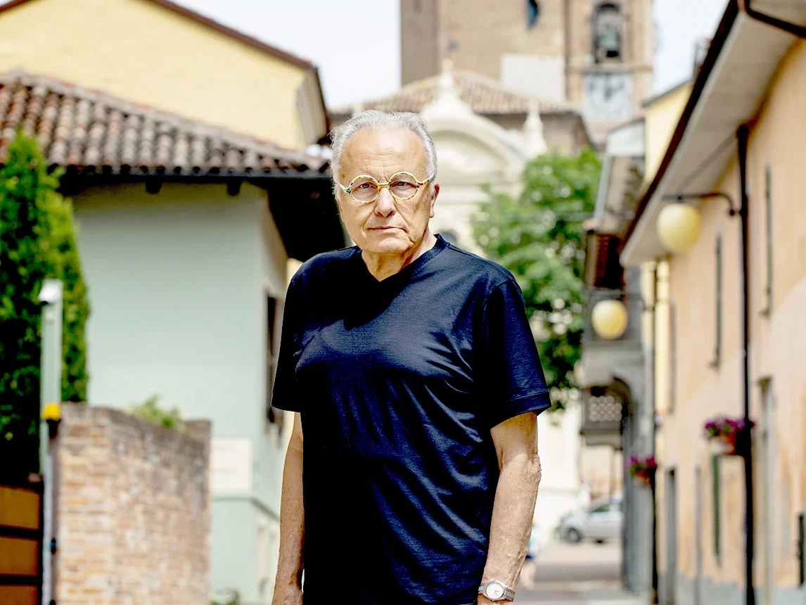 Angelo Gaja, the visionary behind Ca'Marcanda, stands on an Italian street, reflecting on his 1996 leap.