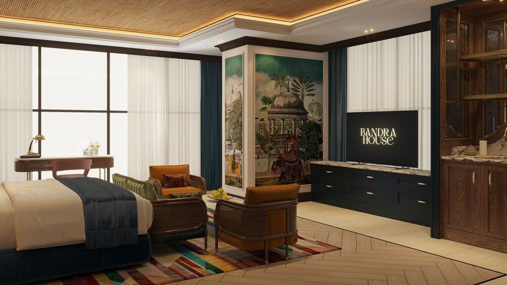 Bandra House IHCL SeleQtions: A luxurious common area with heritage design, rattan chairs, and a vibrant mural.