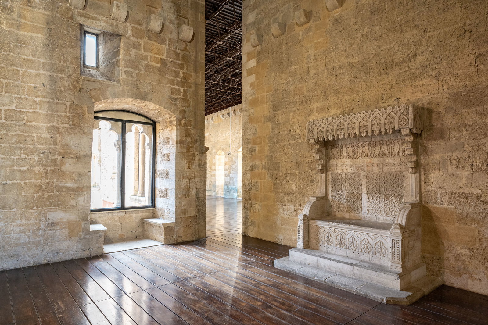 Gioia del Colle showcases an intricately carved stone bench with detailed patterns.