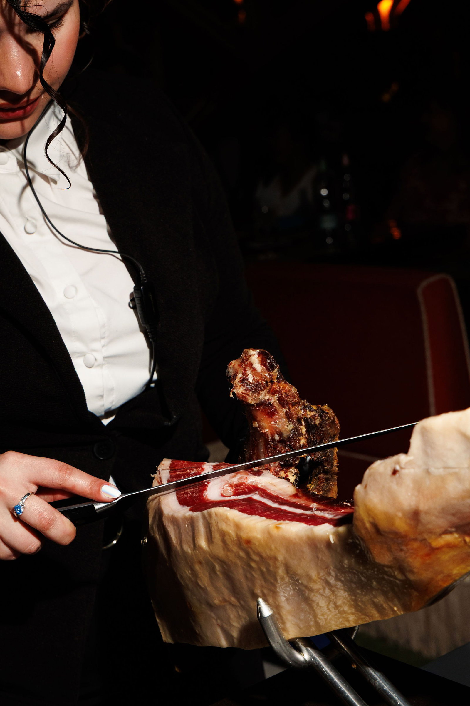 A server carves Spanish suckling pig tableside at José Andrés's Bazaar Meat DC.
