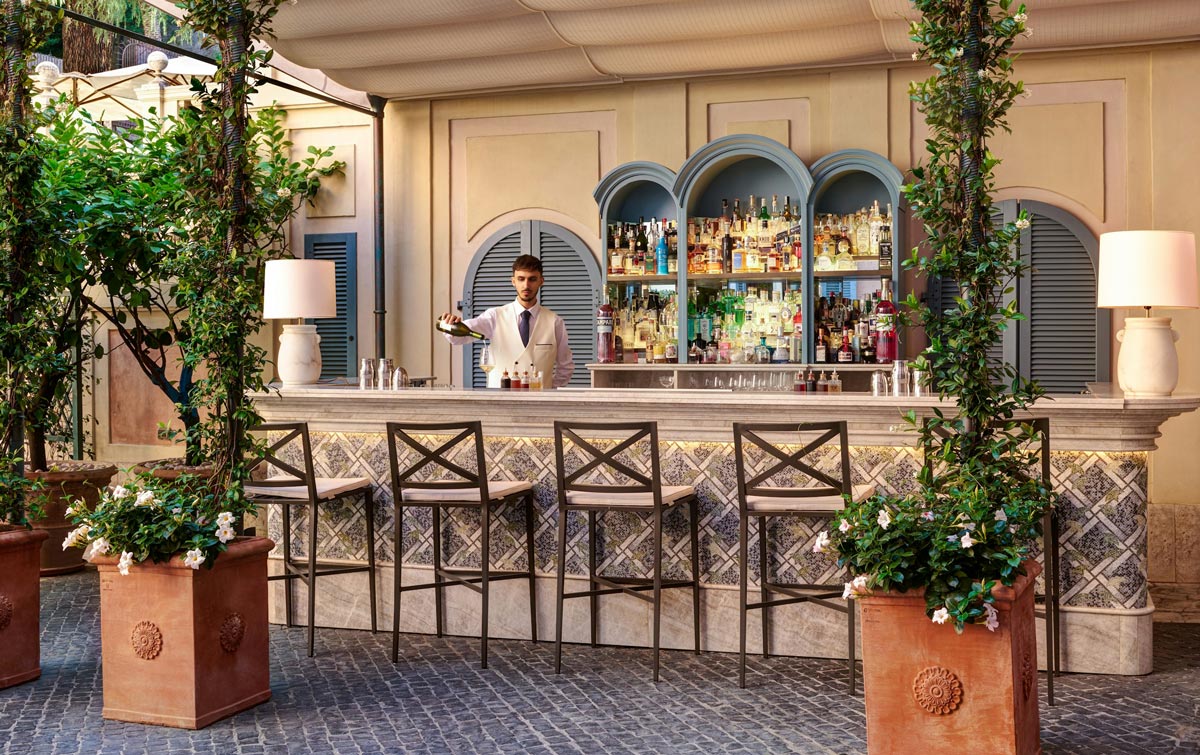 Stravinskij Bar: Luxury in a Garden Oasis, with distinctive blue arched shelves behind the bar.