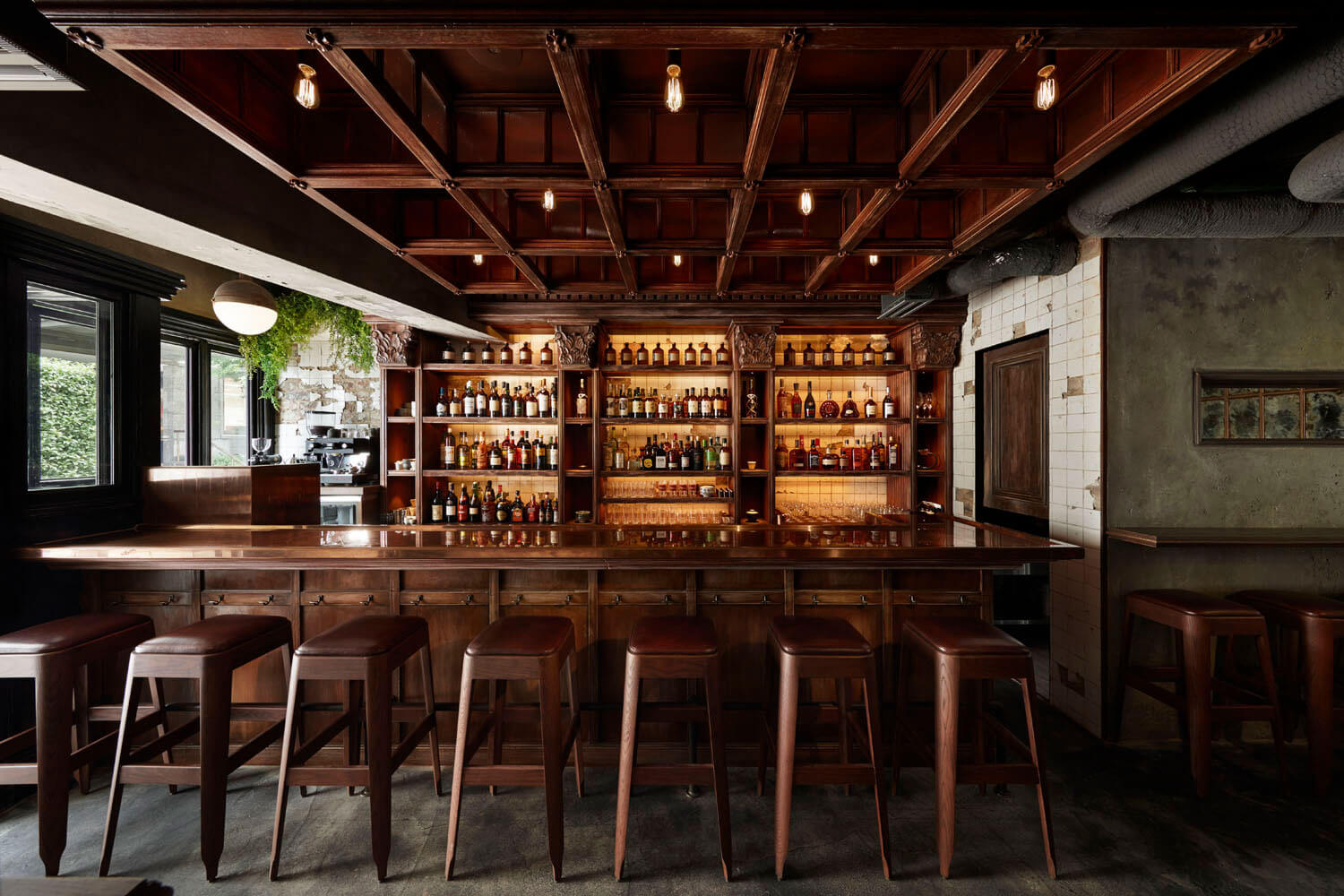 7. The SG Club (Shibuya/Jinnan) boasts a richly detailed dark wood coffered ceiling.