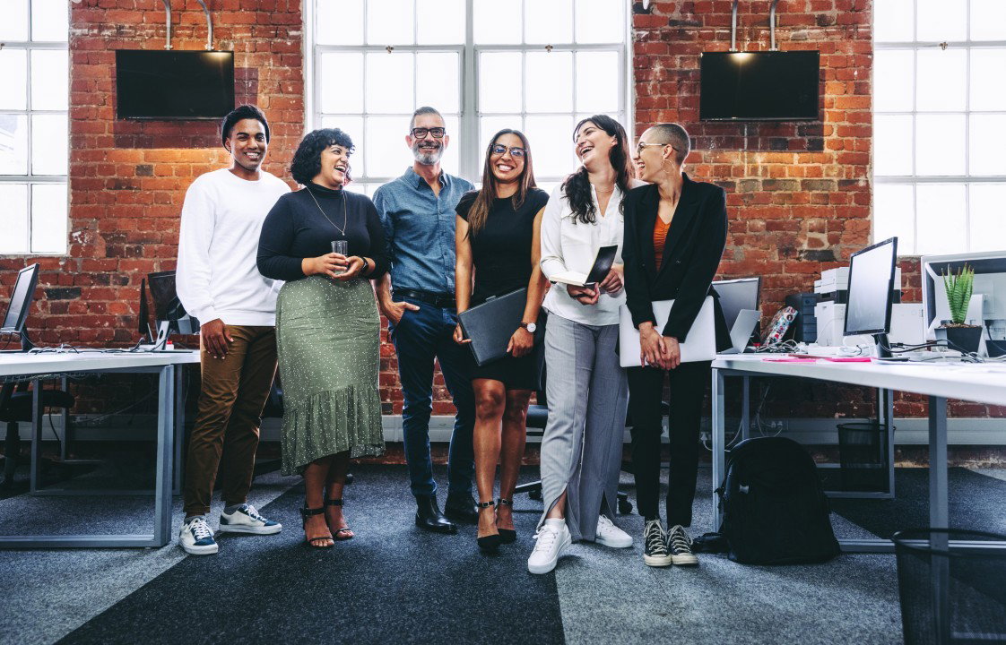 Dress Code and Etiquette: The vibrant red brick walls provide a warm, inviting backdrop for the diverse group.