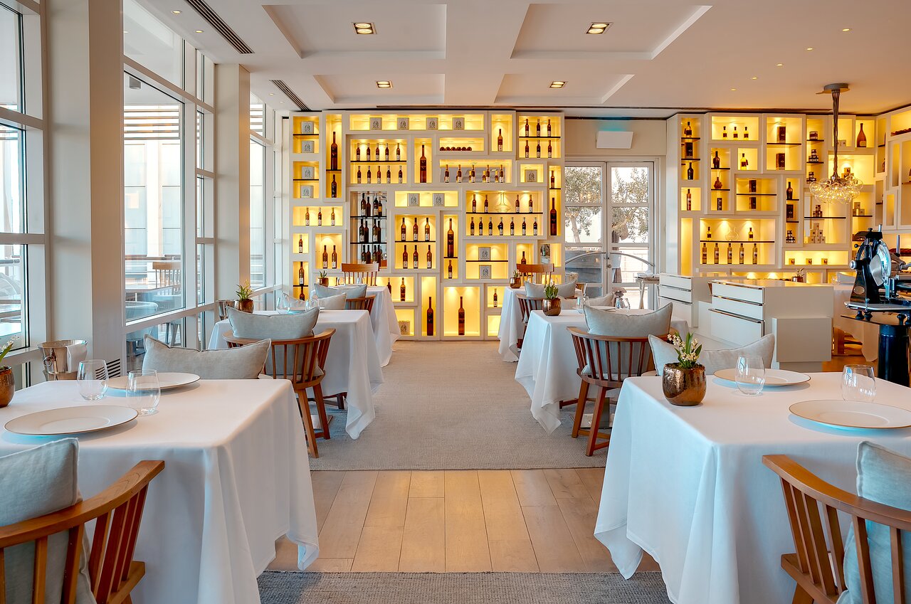 5. Enoteca Paco Pérez boasts a striking wall of warmly illuminated display shelves.
