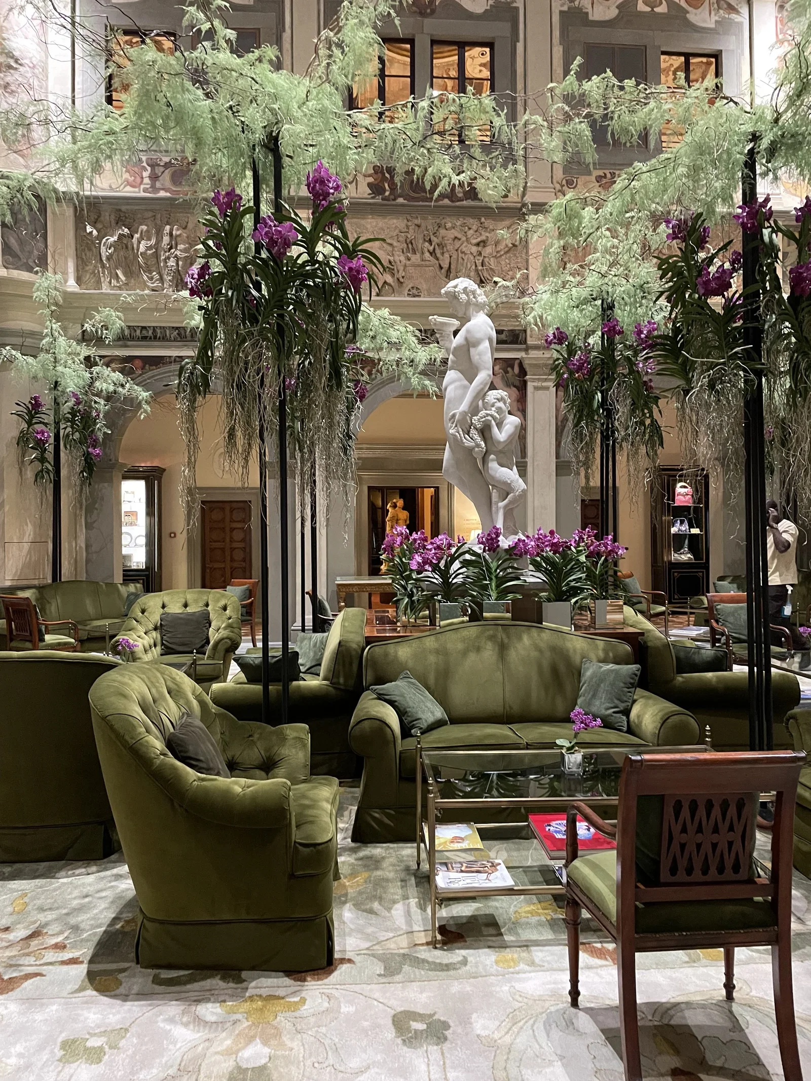 3. Il Palagio features plush olive green seating arranged in a luxurious, inviting lounge setting.