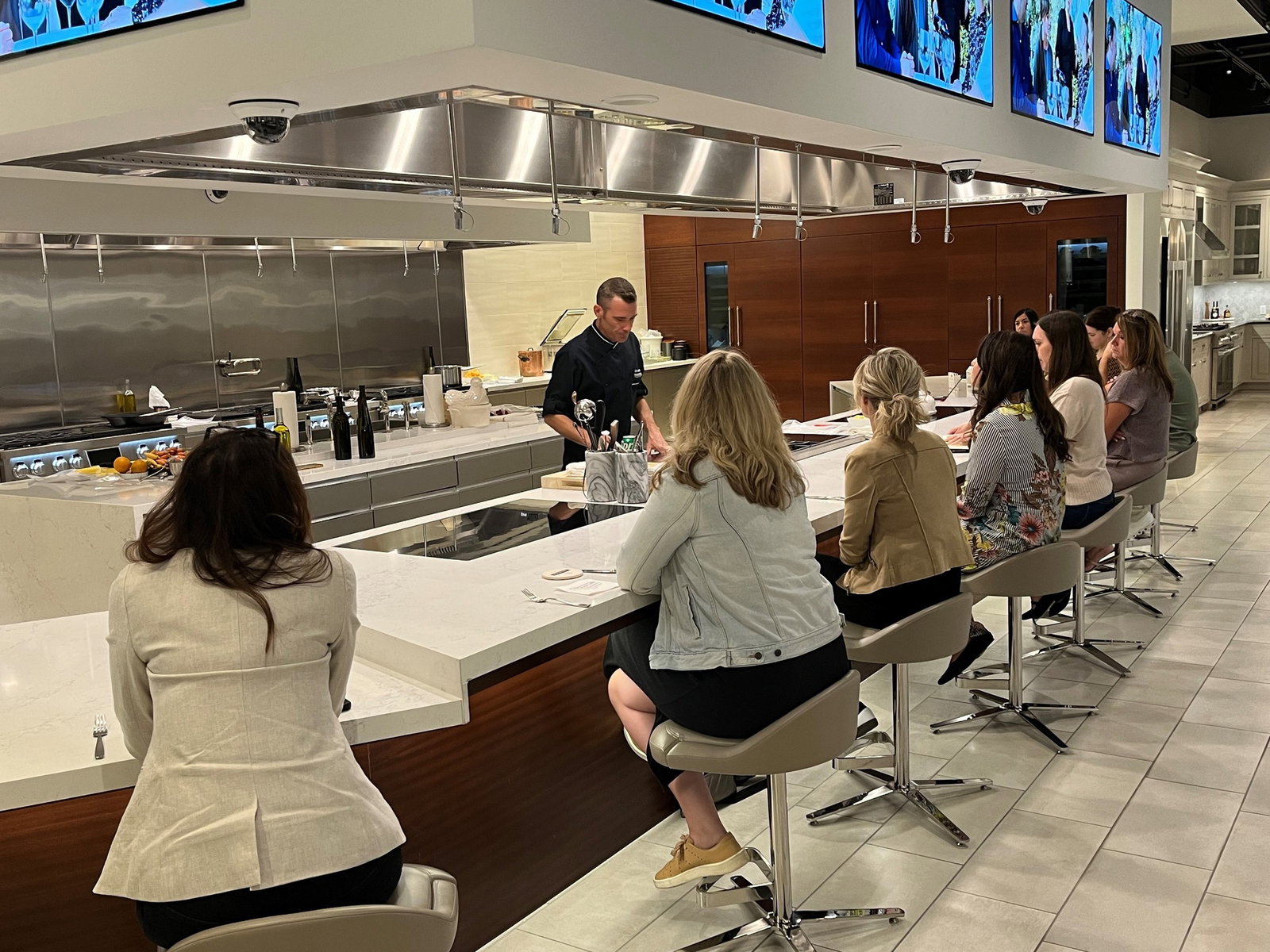 Culinary Philosophy and Signature Experiences features a chef in a sleek black jacket.