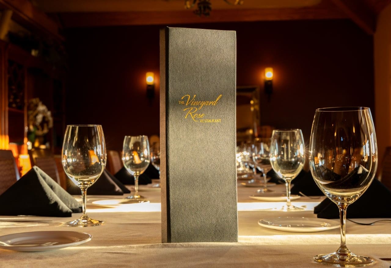 Wine Programs and Service Excellence feature elegant clear wine glasses at each setting.
