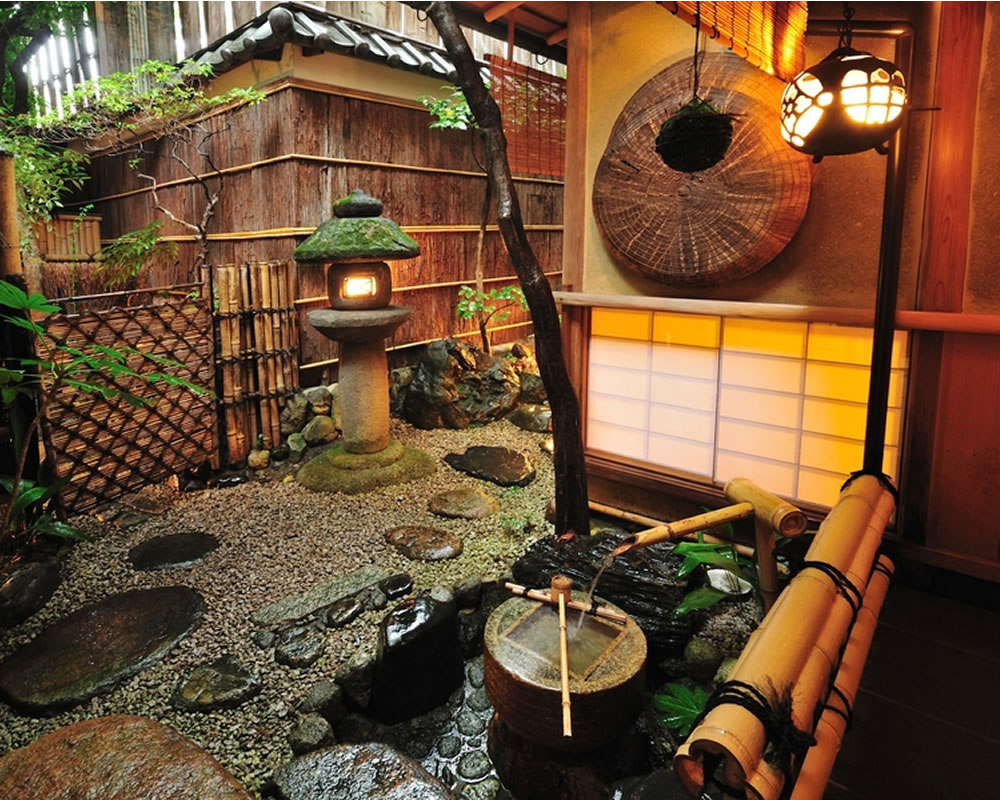 5. Isshisoden Nakamura features a moss-covered stone lantern illuminating its serene garden.