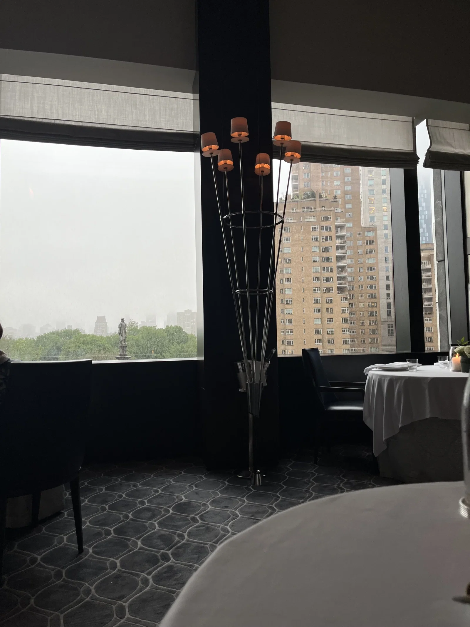 3. Per Se showcases a distinctive tall lamp with multiple warm-toned shades.