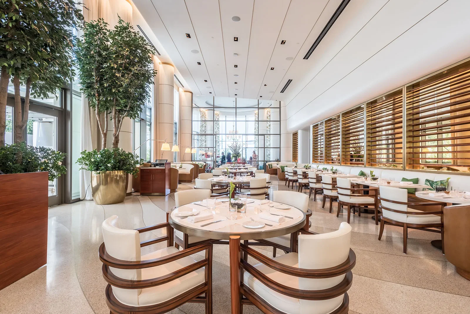 8. Jean Georges features a bright, spacious dining room with tall indoor trees.