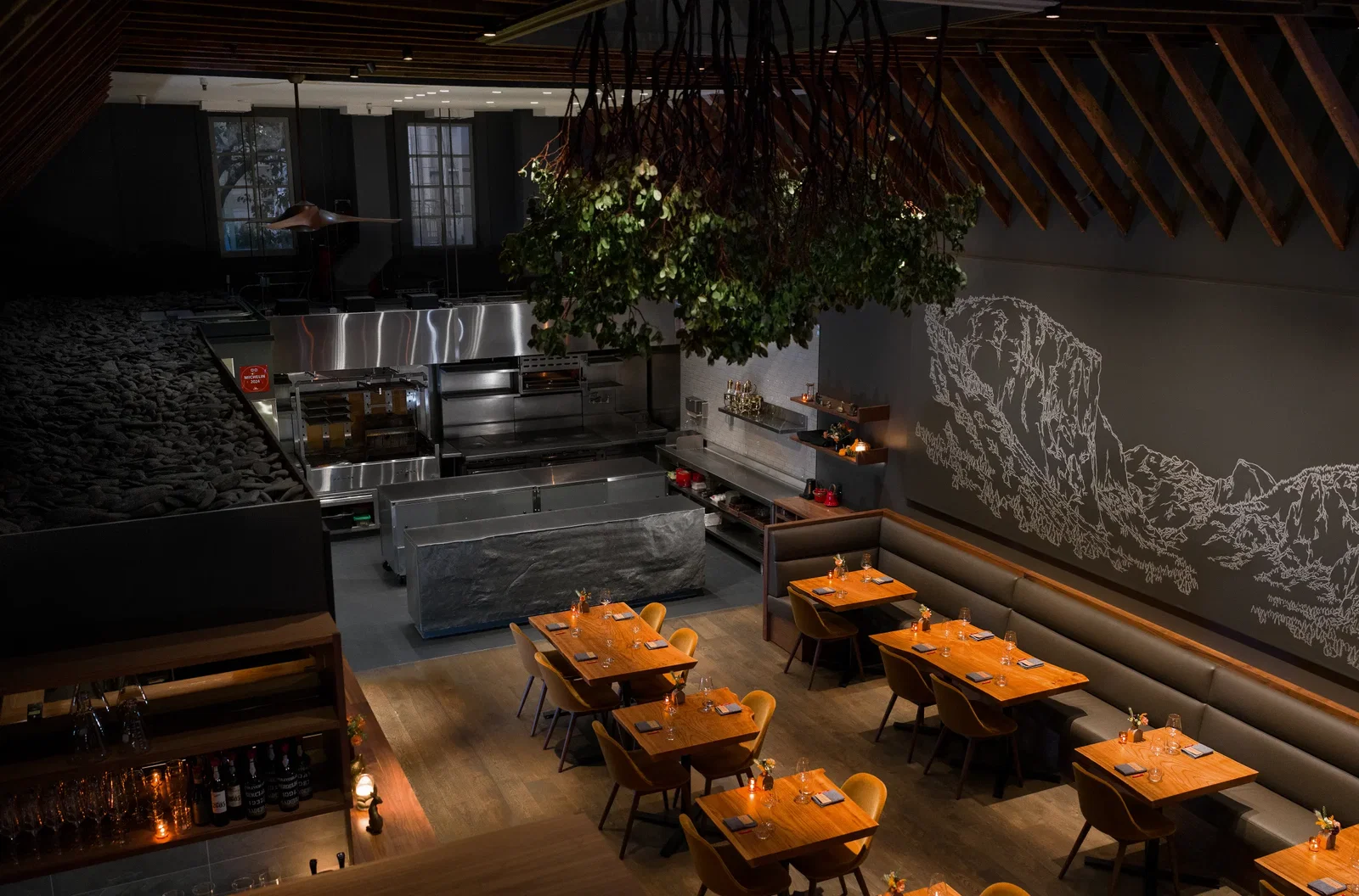 10. Lazy Bear features a canopy of lush green foliage hanging from the ceiling.