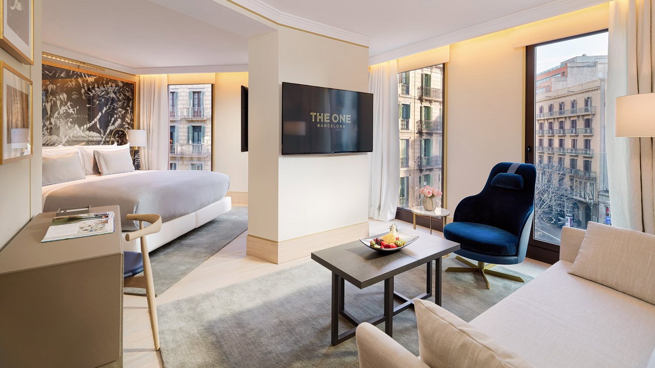 Top Picks: Barcelona's Finest Luxury Hotels showcases a luxurious deep blue armchair by the window.