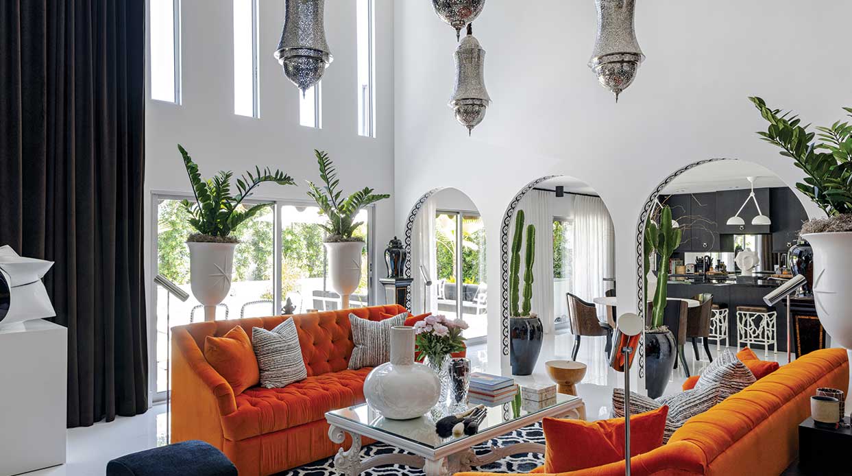 Historic Charm vs. Contemporary Style features vibrant orange sofas creating a bold focal point.