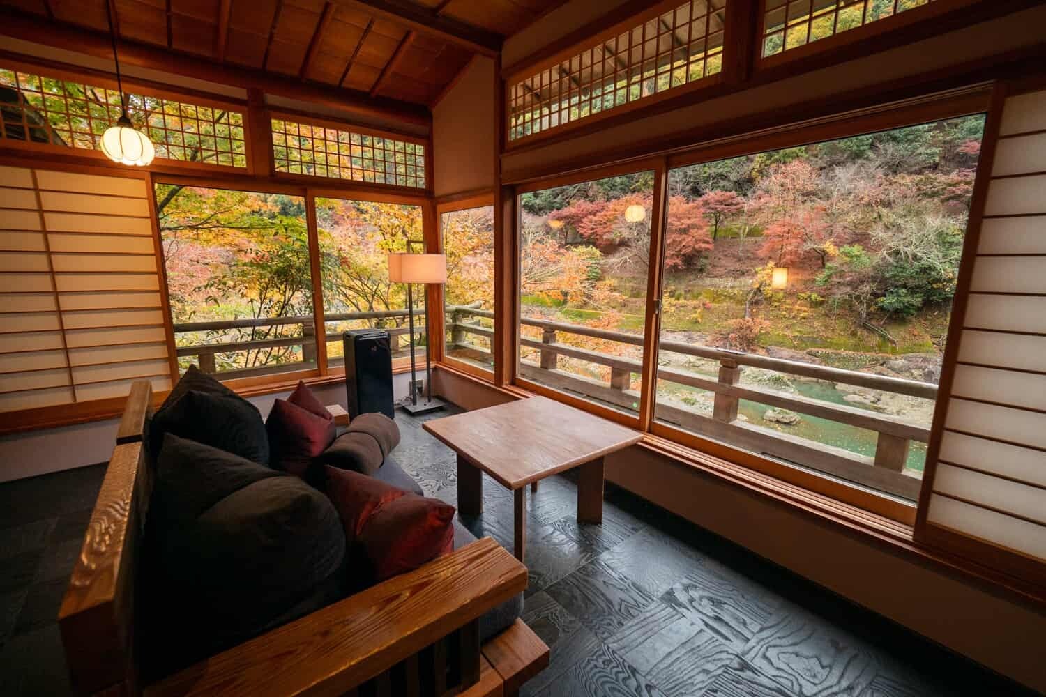 5. Hoshinoya Kyoto frames vibrant autumn foliage through its large, traditional windows.