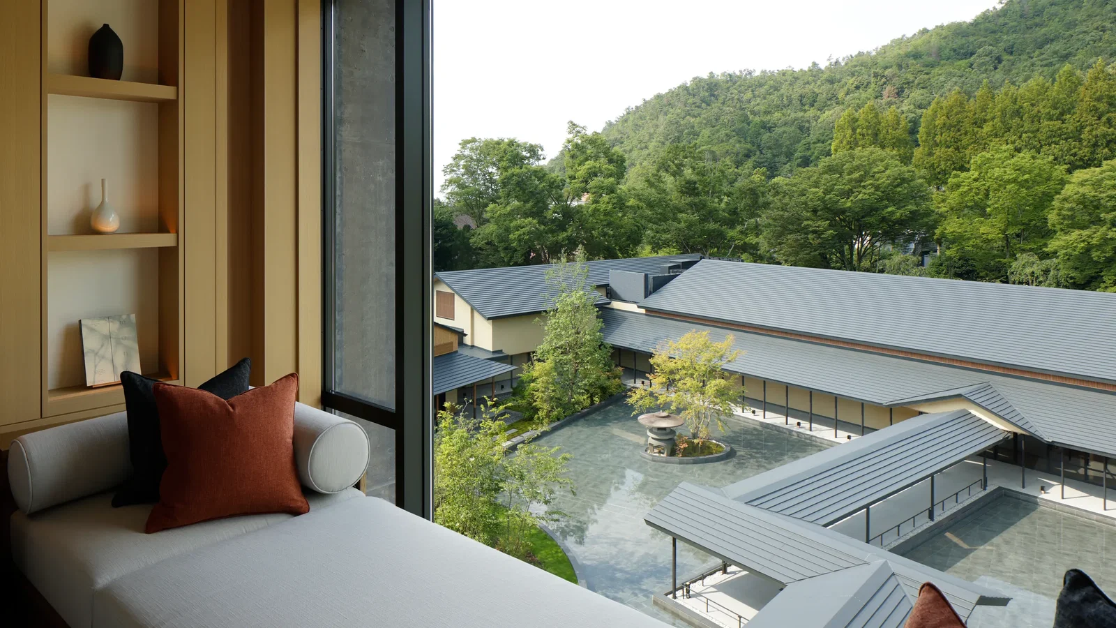 9. ROKU KYOTO, LXR Hotels & Resorts showcases a serene central water feature reflecting the surrounding traditional architecture.