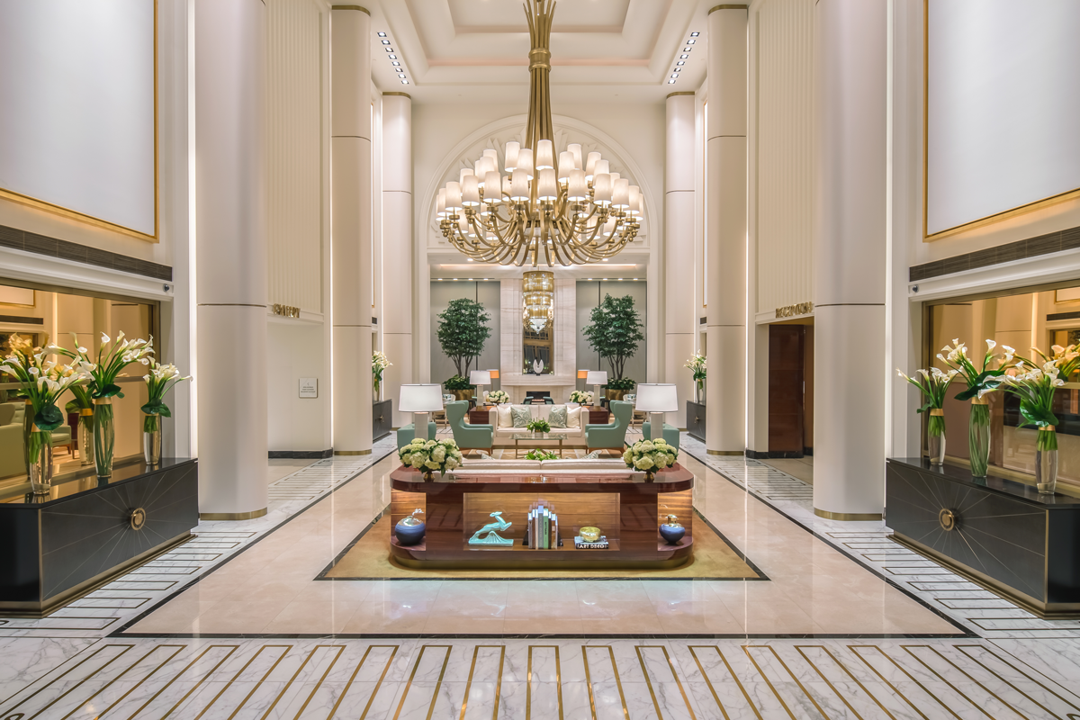 3. Waldorf Astoria Beverly Hills features a striking, multi-tiered chandelier illuminating its grand entrance.
