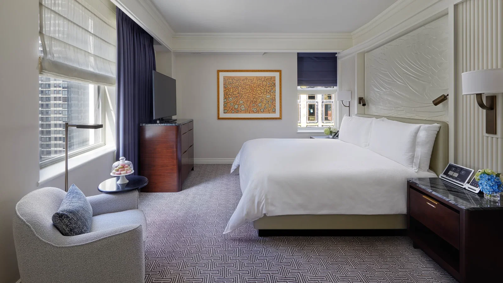 6. The Peninsula New York features a serene bedroom with a striking geometric pattern on the carpet.