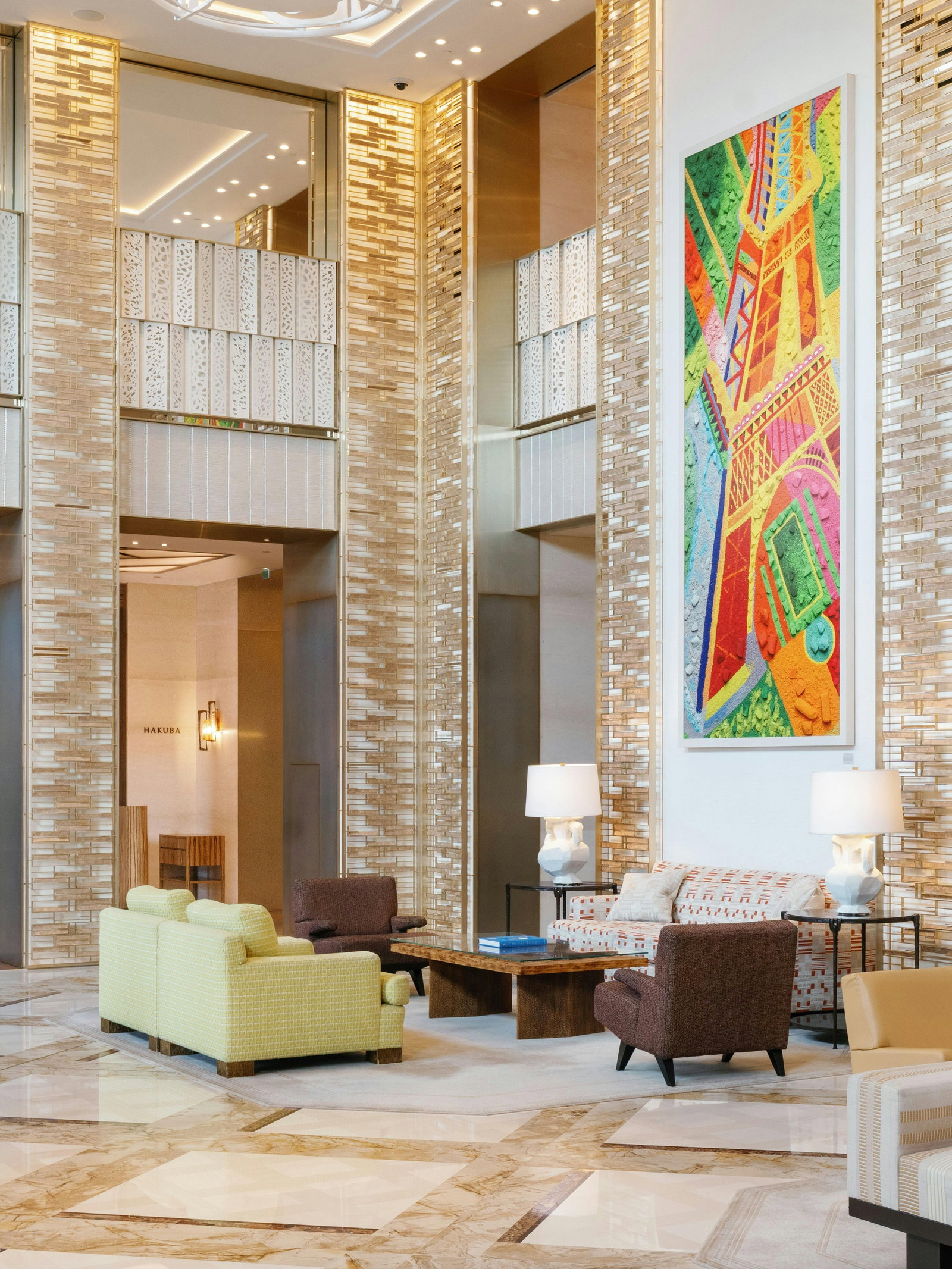 5. Cheval Blanc Paris, with its grand lobby featuring a vibrant, textured artwork.