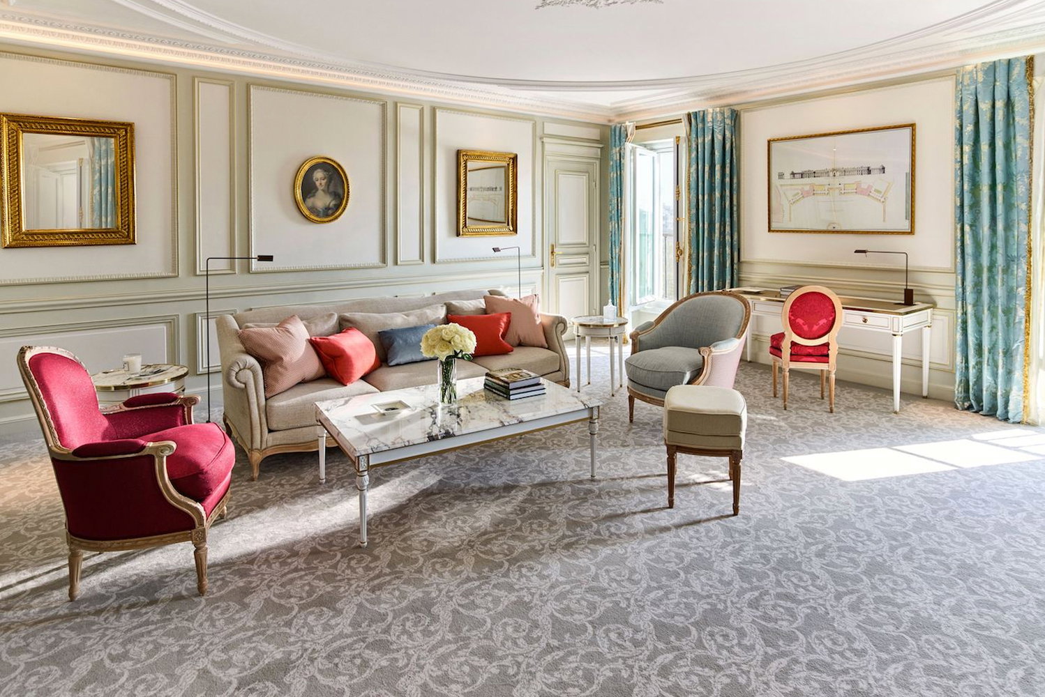 7. Hôtel Le Meurice highlights vibrant red armchairs adding a striking pop of color to the room.