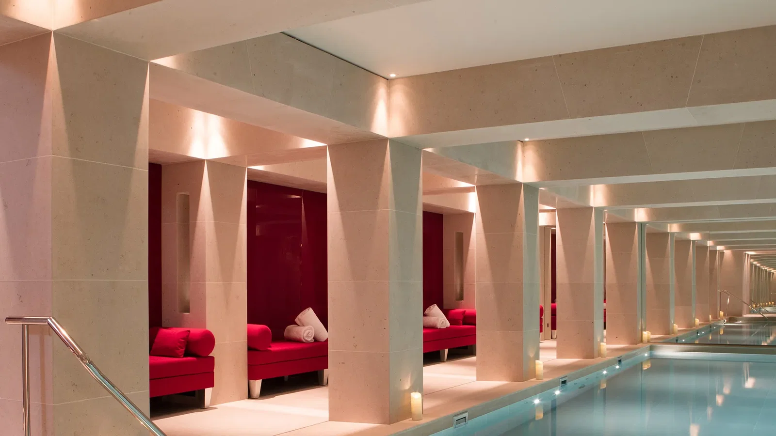 9. La Réserve Paris showcases its elegant indoor pool, lined with inviting red daybeds.