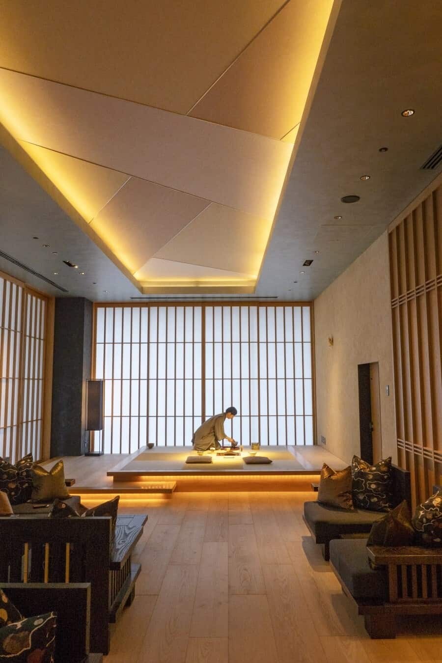 7. HOSHINOYA Tokyo features a central raised platform, beautifully illuminated for a traditional tea ceremony.