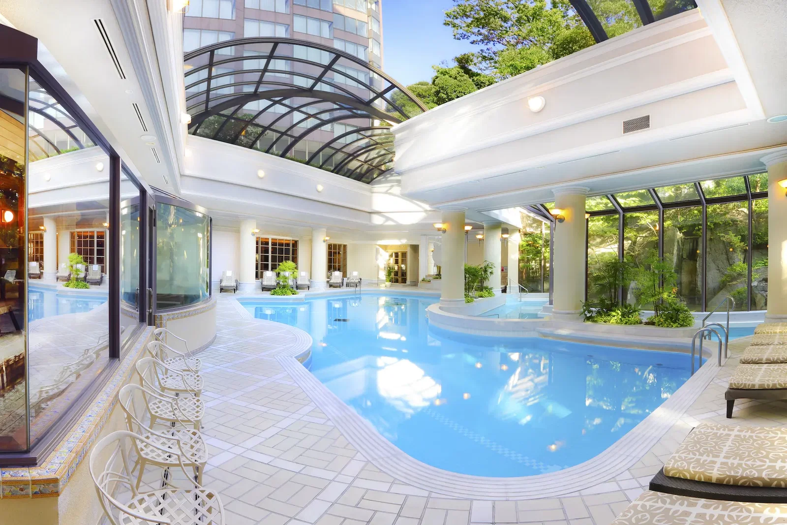8. Hotel Chinzanso Tokyo features a stunning indoor pool bathed in natural light from its arched glass roof.
