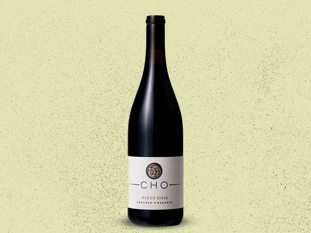 Bottle of CHO Pinot Noir on a textured background.