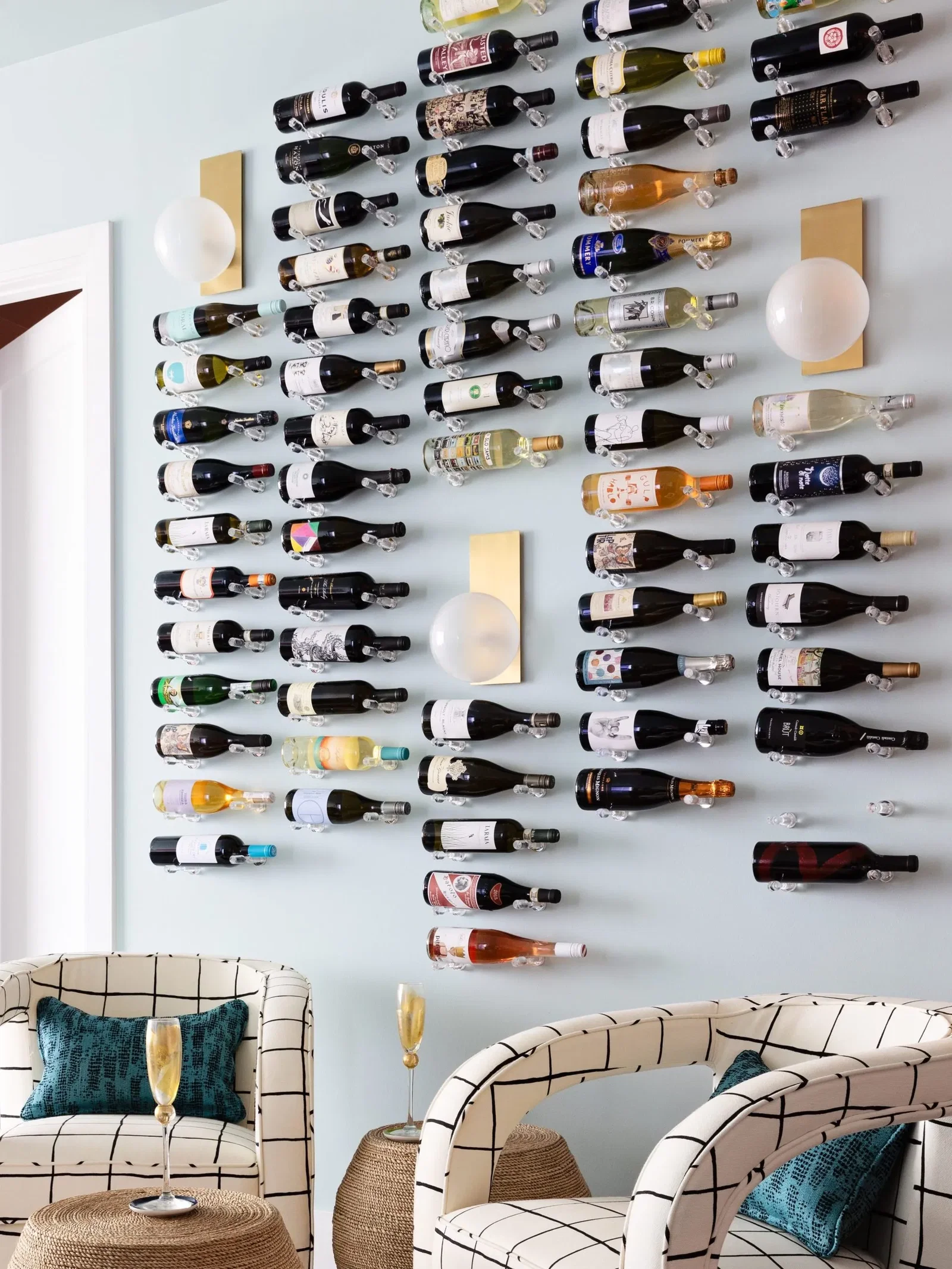 The Differences Between Bordeaux and Burgundy Wines, showcasing a wall filled with bottles of varying wine colors.