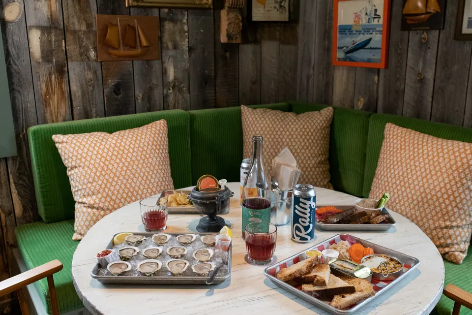 Island Creek Raw Bar (Seaport) features a vibrant green corduroy banquette.