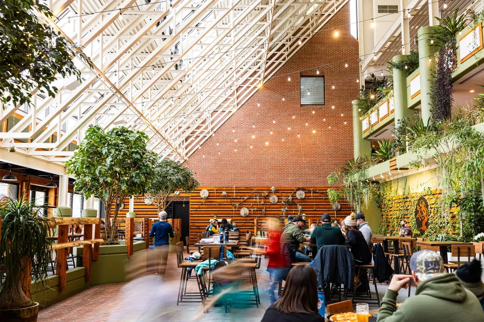 Tree House Brewing Company (Downtown) features an impressive high ceiling with white geometric trusses.