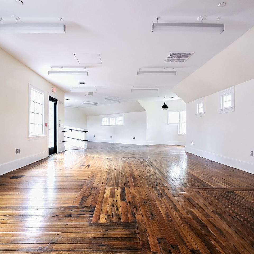 Charles River Speedway (Brighton) boasts a warm, varied wooden floor that reflects the bright overhead light.