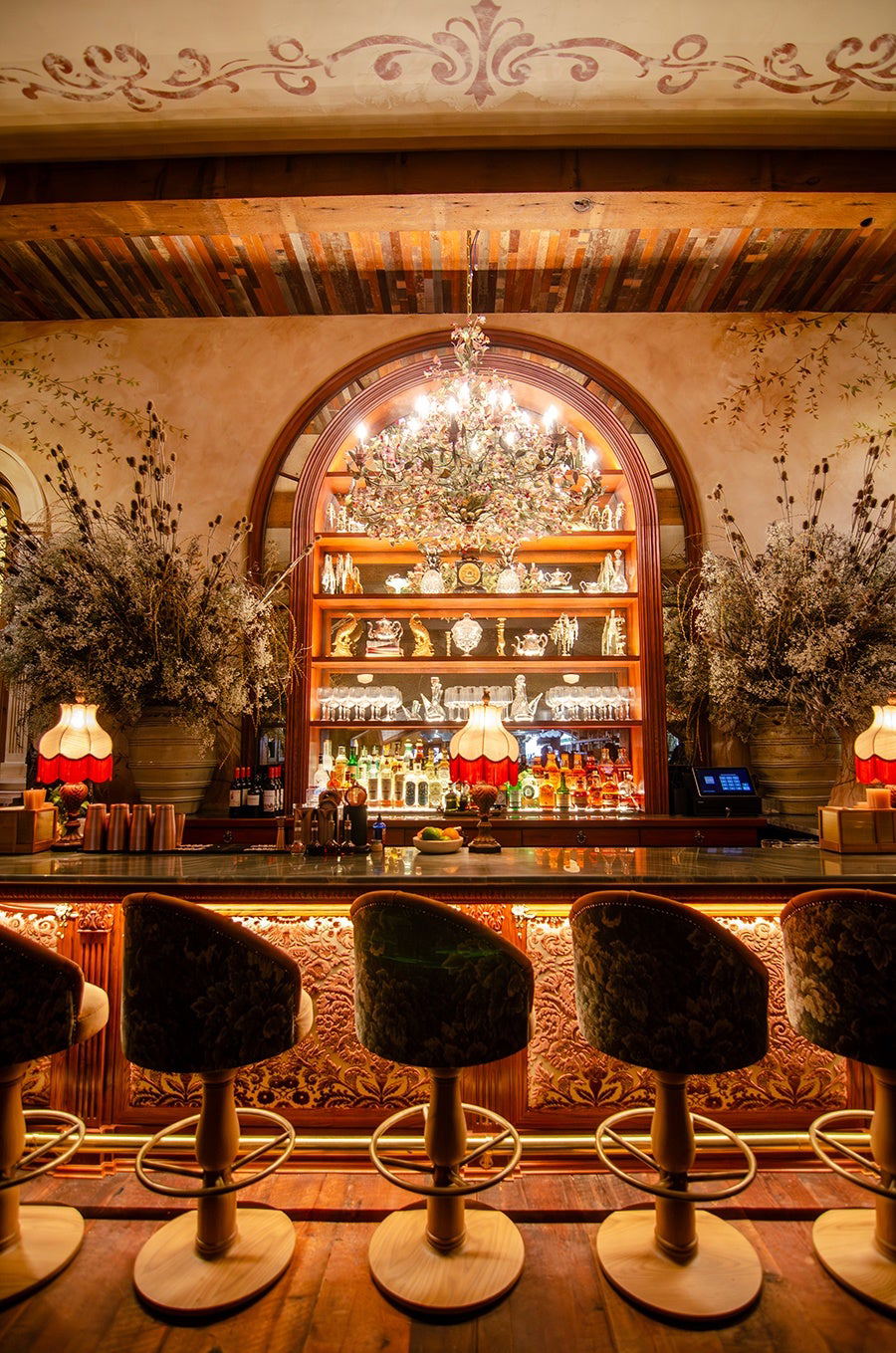 Dalia (South Boston) features a dazzling, multi-tiered chandelier illuminating the opulent bar.