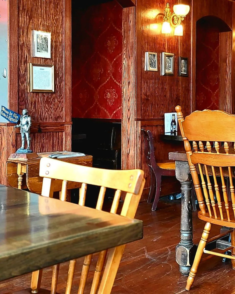 Mother’s East Tavern (South Boston) showcases its distinctive rich red patterned wallpaper.