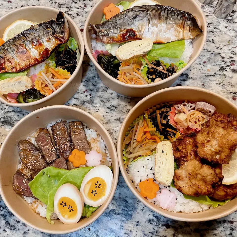 Nagomi Bento (Cambridge) displays a variety of dishes, each with flower-shaped garnishes.