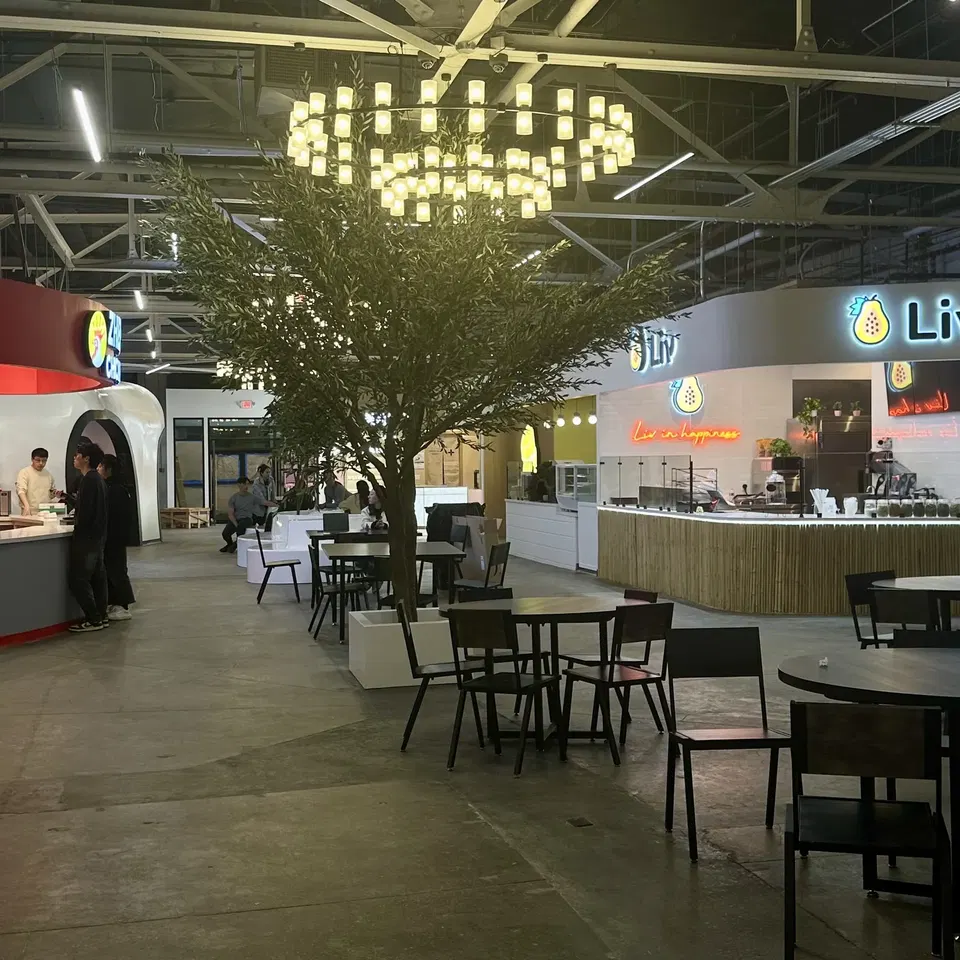 Novo Marketplace (Allston) is illuminated by a striking circular chandelier.