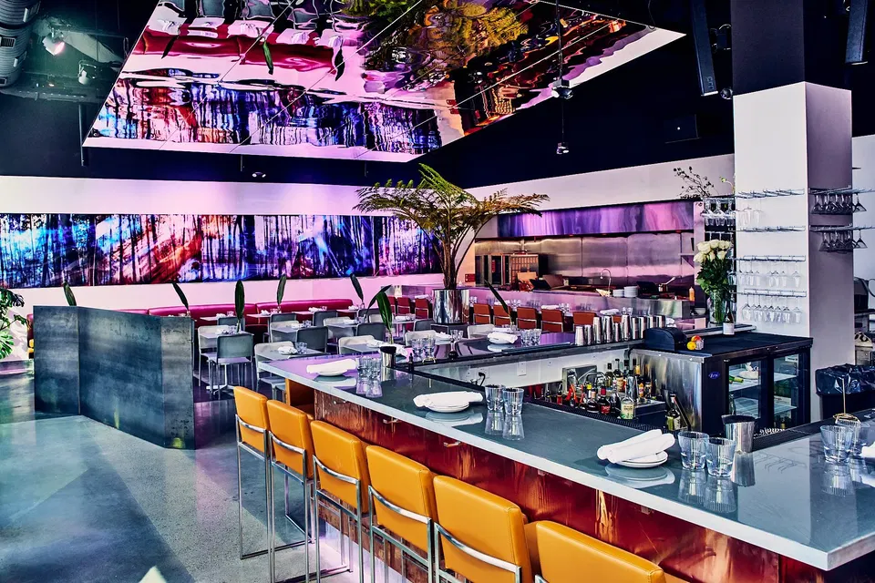 Rosa y Marigold (Back Bay) features a striking mirrored ceiling reflecting vibrant colors throughout the space.