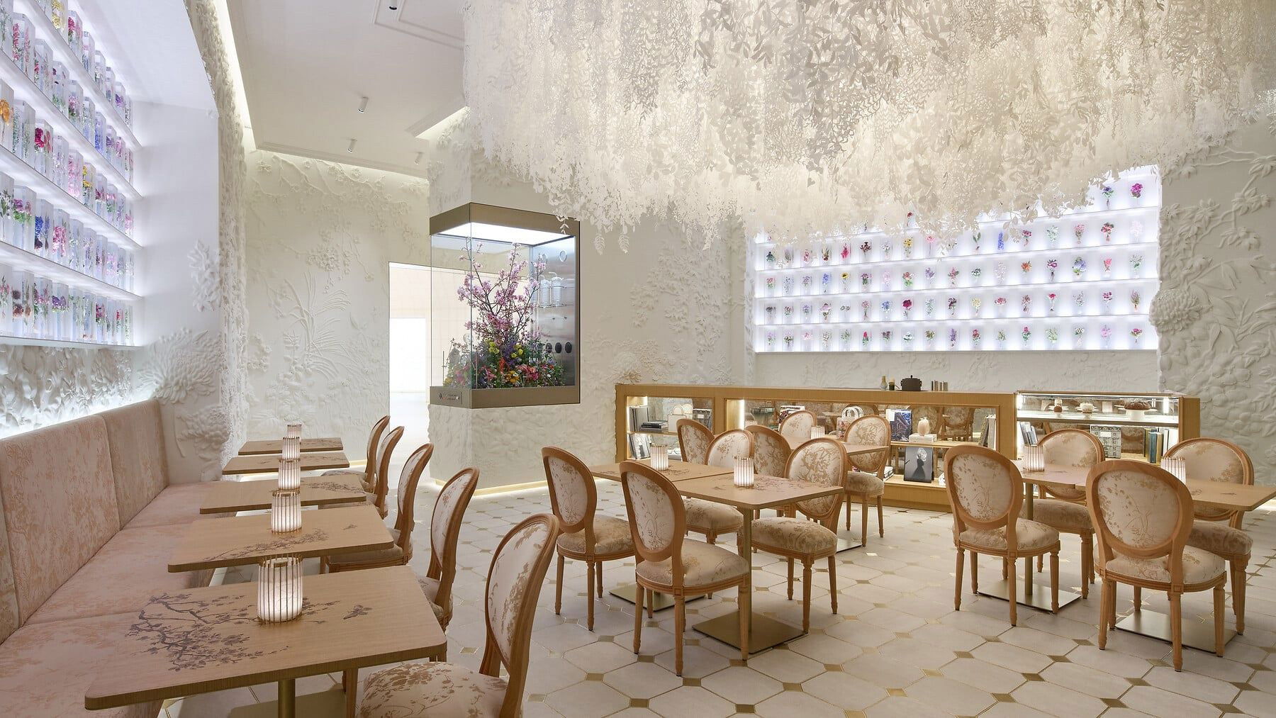 café dior by anne-sophie pic features a dramatic paper-cut chandelier and elegant floral decor.