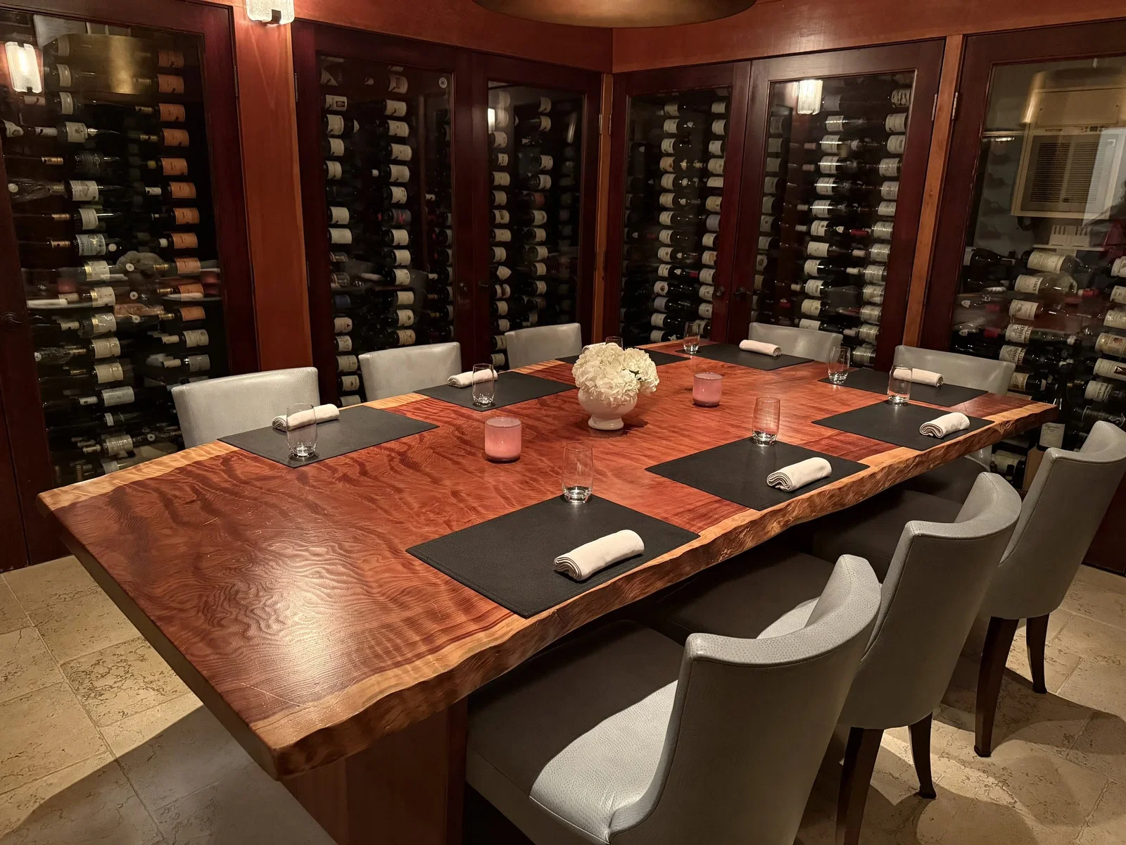 Planning Your Visit to Aubergine Carmel, featuring a private dining room enclosed by a vast wine cellar.