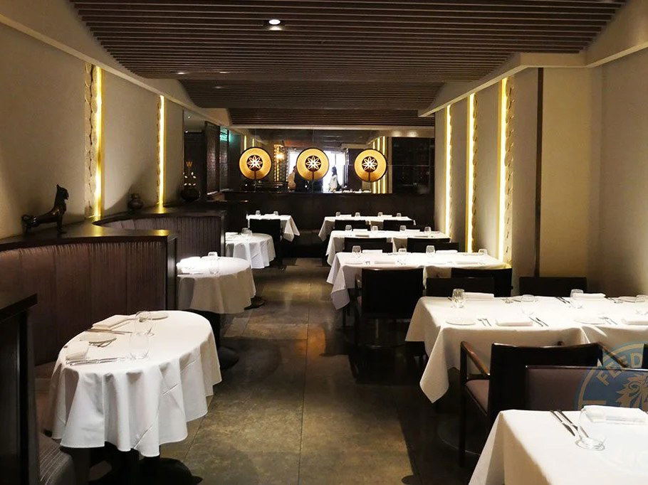 Elegant restaurant interior with white-clothed tables and warm lighting