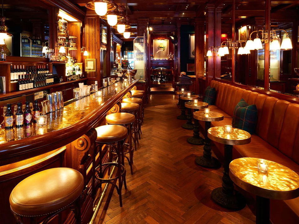 The Polo Bar's upstairs bar area, with its mahogany, leather, and equestrian decor, awaits guests.